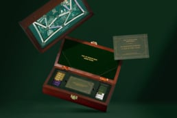 Luxury Monopoly game set with chips, cards, and a wooden box for premium gaming.