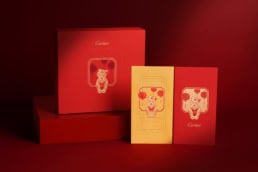 Elegant Cartier gift boxes featuring little panther illustrations, showcasing luxury packaging design with vibrant red and gold accents, perfect for high-end jewelry presentation.